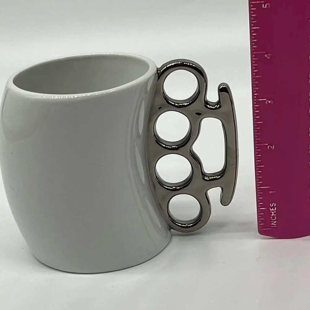 Brass knuckles coffee mug white and silver